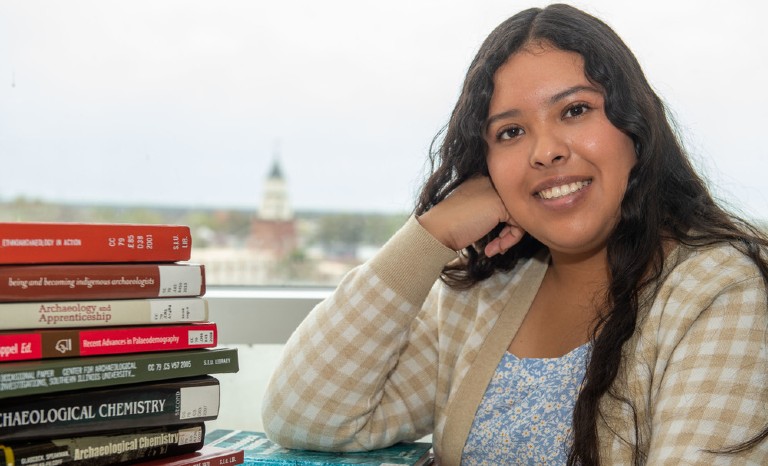 SIU student with English textbooks