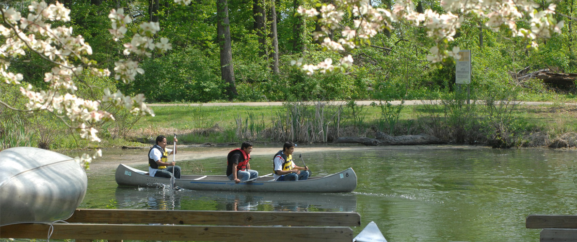 CESL students on campus lake in canoe